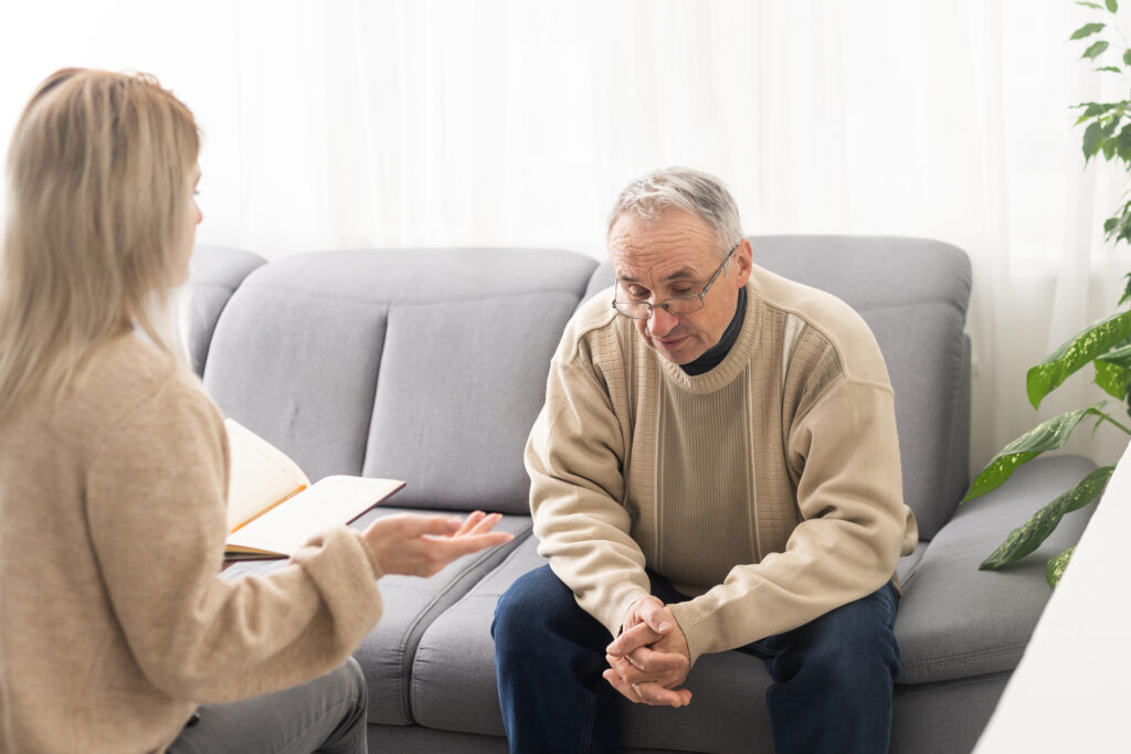 old man talking to female doctor