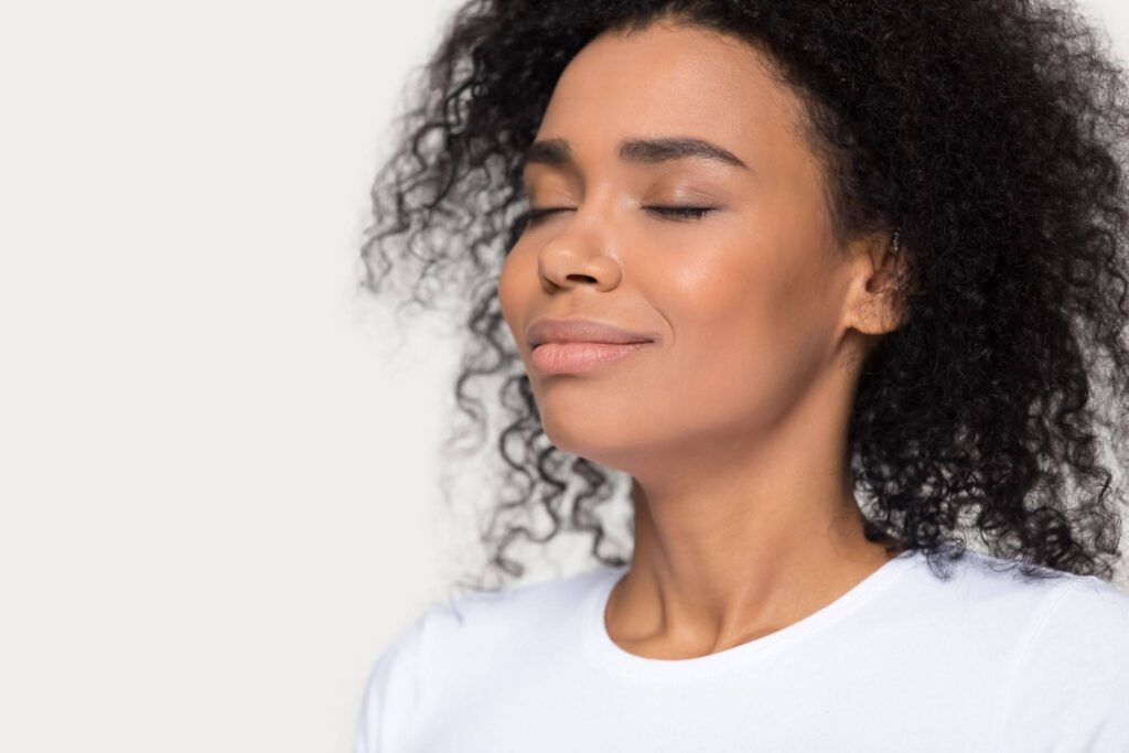 A woman breathes in deeply